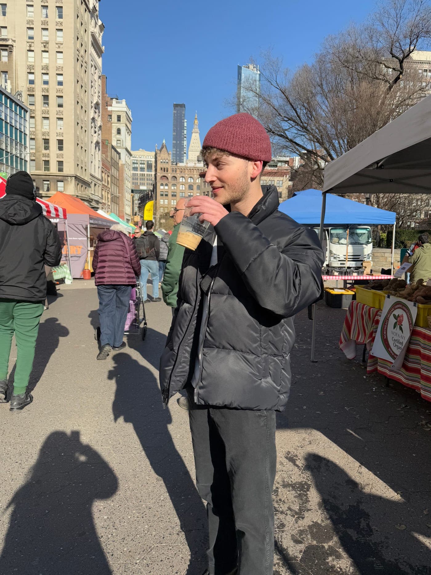 Josh with an iced coffee at a farmers market in New York